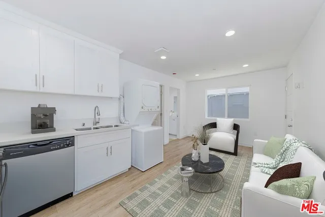 a kitchen with granite countertop white cabinets and white appliances