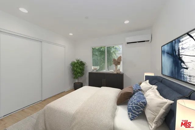a view of a room with wooden floor and white walls