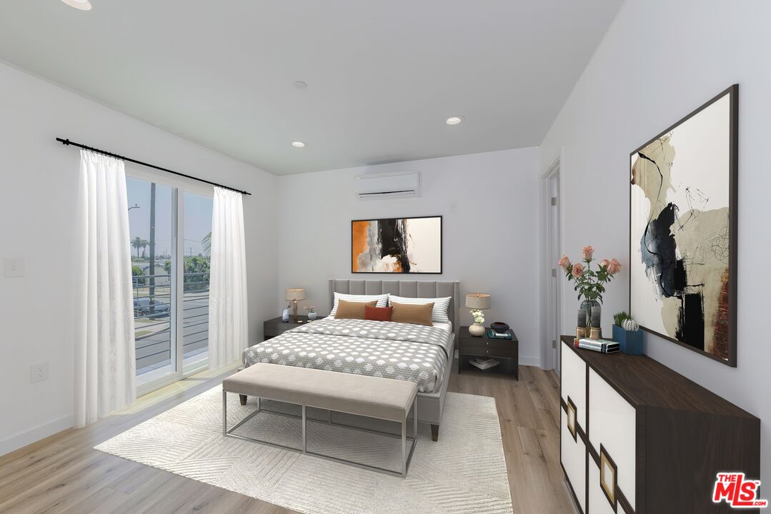 1105 East 103rd Place Los Angeles, CA 90002 - Photo 4 of 56 a bedroom with a large bed and a balcony
