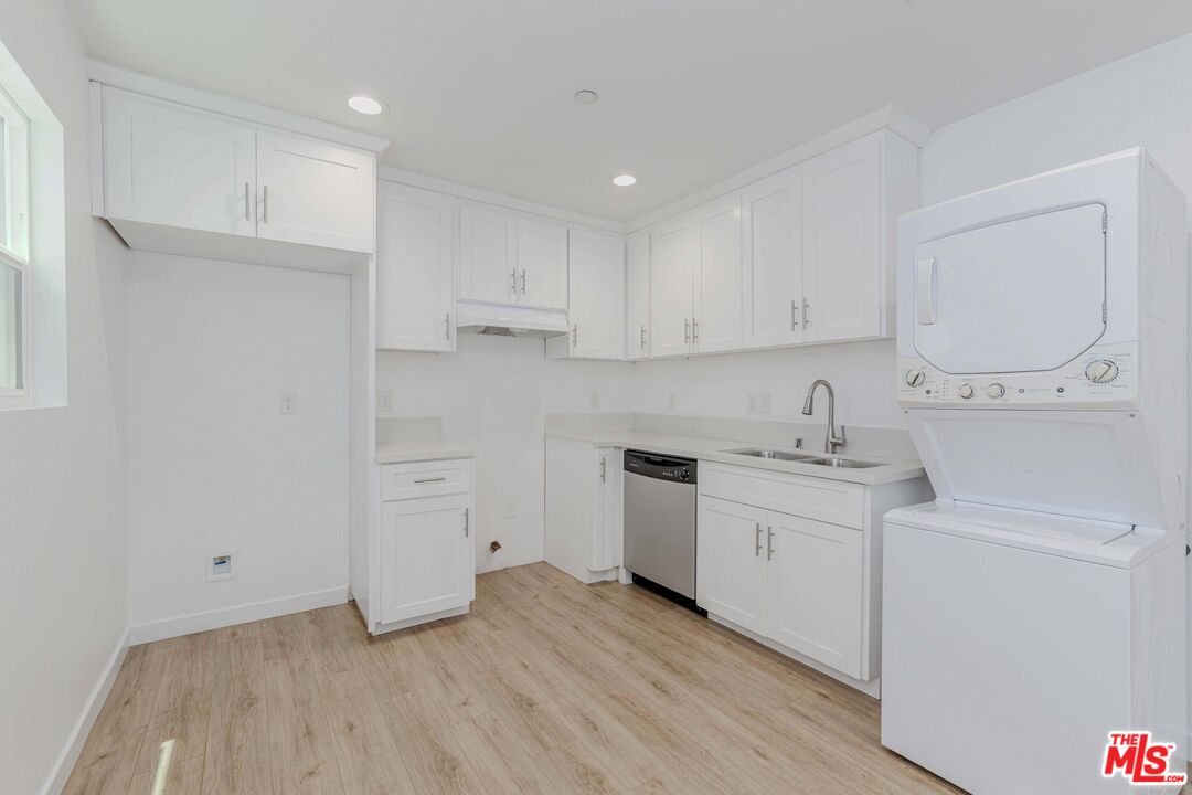 1105 East 103rd Place Los Angeles, CA 90002 - Photo 41 of 56 a kitchen with white cabinets and sink