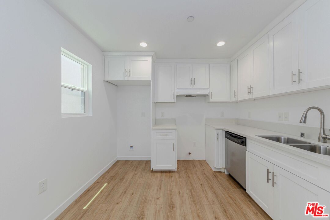 1105 East 103rd Place Los Angeles, CA 90002 - Photo 42 of 56 a view of a kitchen with wooden floor