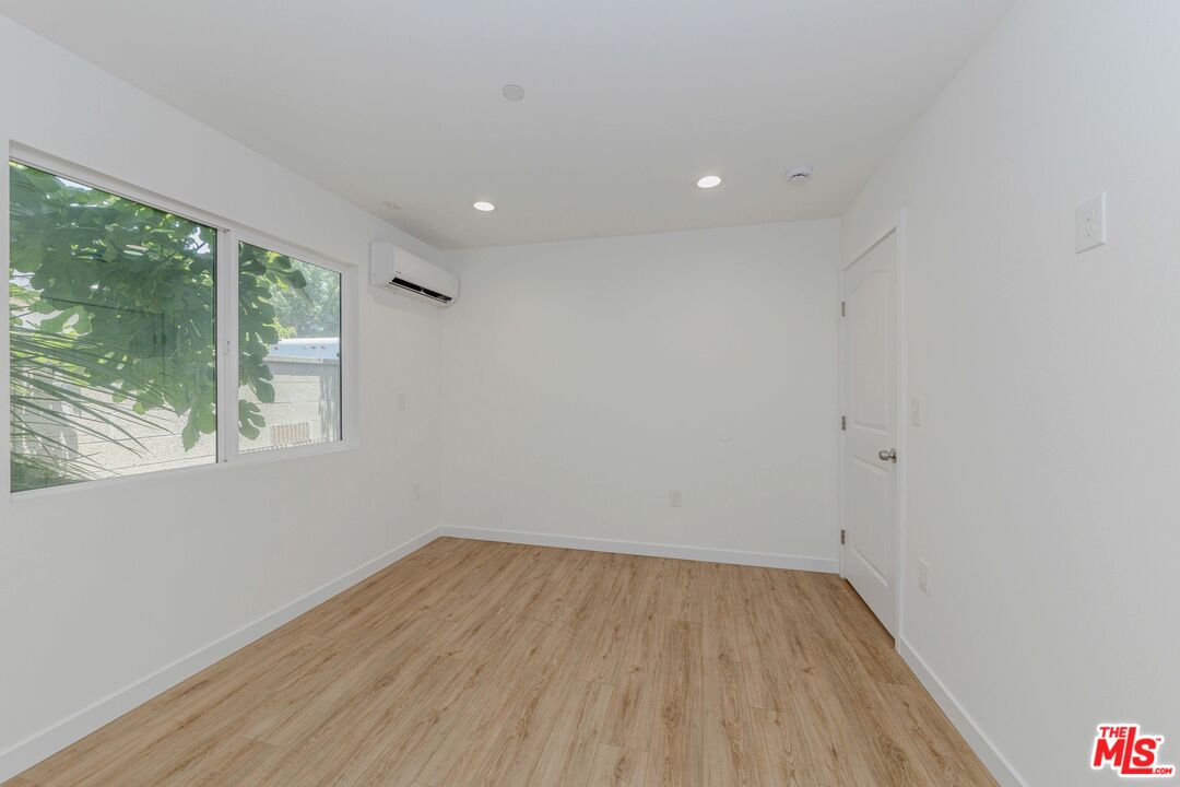 1105 East 103rd Place Los Angeles, CA 90002 - Photo 46 of 56 a view of room with window and wooden floor