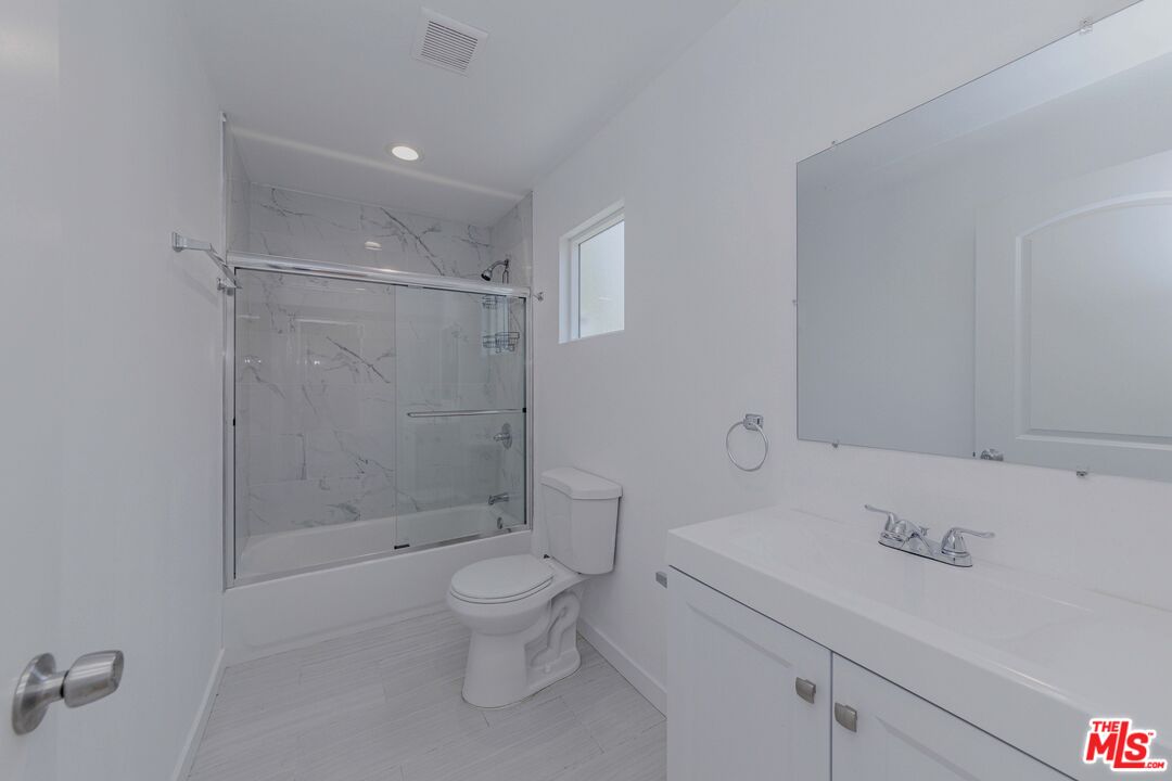 1105 East 103rd Place Los Angeles, CA 90002 - Photo 48 of 56 a bathroom with a sink a toilet and shower