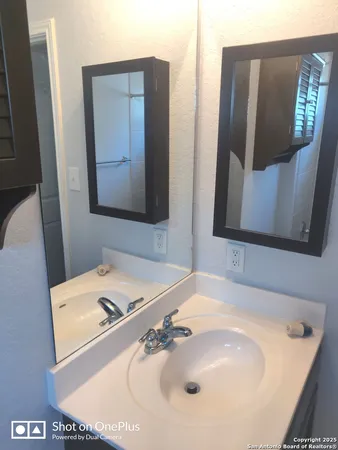 a bathroom with a sink and mirror