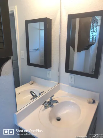 a bathroom with a sink and mirror