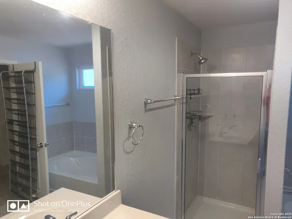 a bathroom with a shower and a sink
