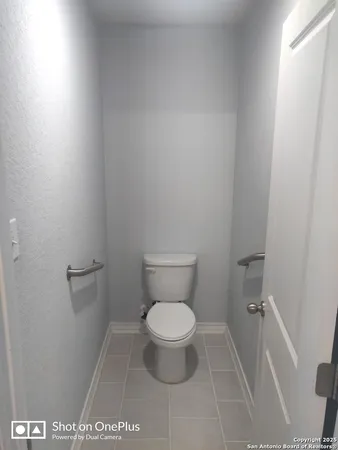 a bathroom with a toilet and a mirror