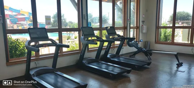 a living room with furniture and floor to ceiling windows