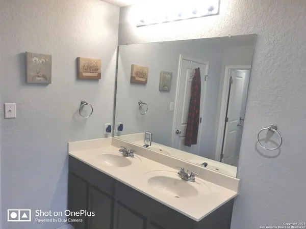 a bathroom with a sink vanity and a mirror