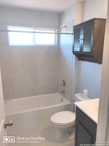 a bathroom with a toilet a sink and bathtub