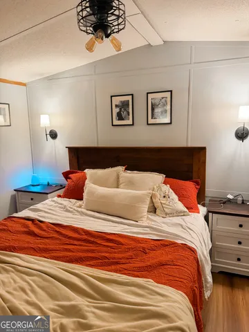 a bedroom with a bed and a night stand