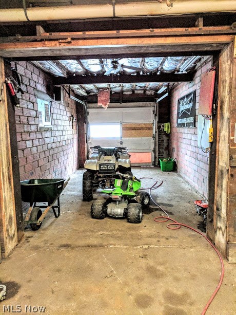 2320 Copley Road Akron, OH 44320 - Photo 28 of 35 East bay on lower level of workshop/garage with roll up door to the rear yard and secondary driveway.