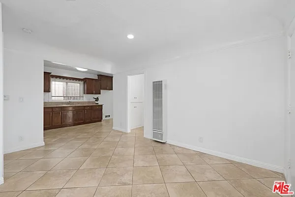 a view of a kitchen with a sink and a refrigerator