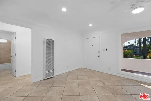 an empty room with windows and entrance