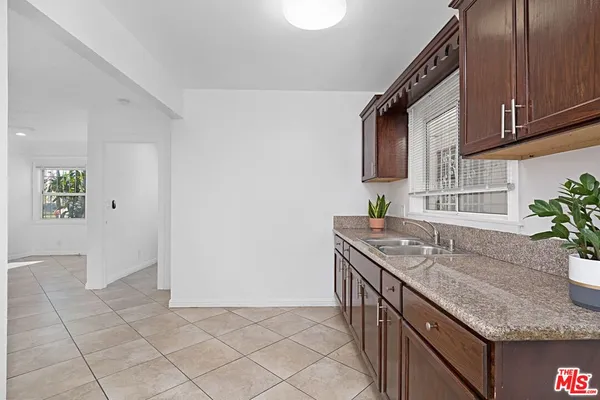 a kitchen with granite countertop a sink and a stove