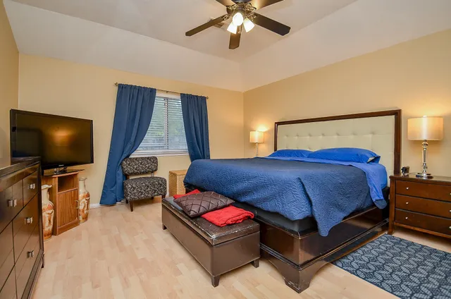 a bedroom with a bed and flat screen tv