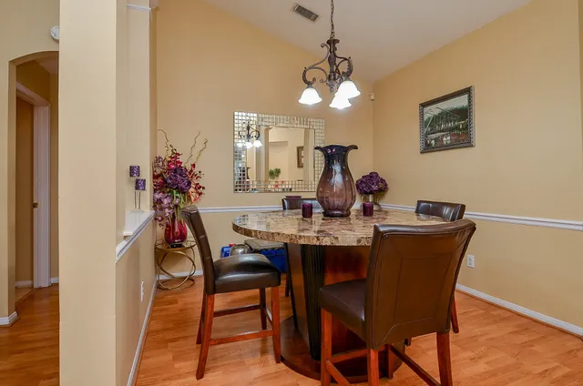 a dining room with furniture and chandelier