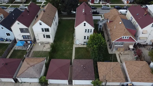 an aerial view of multiple houses with a yard