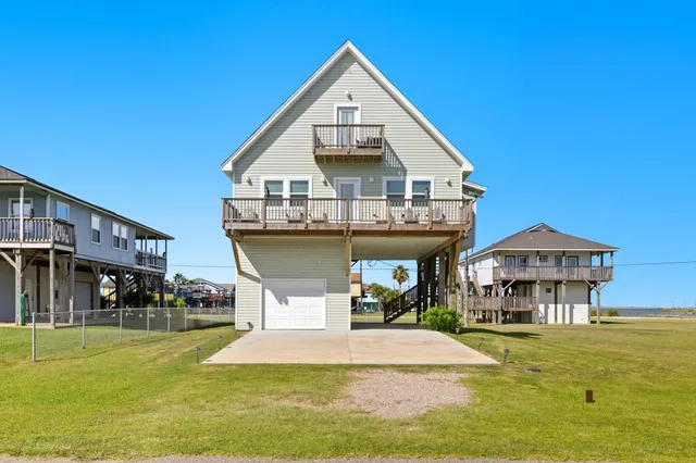 a front view of a house with swimming pool having outdoor seating
