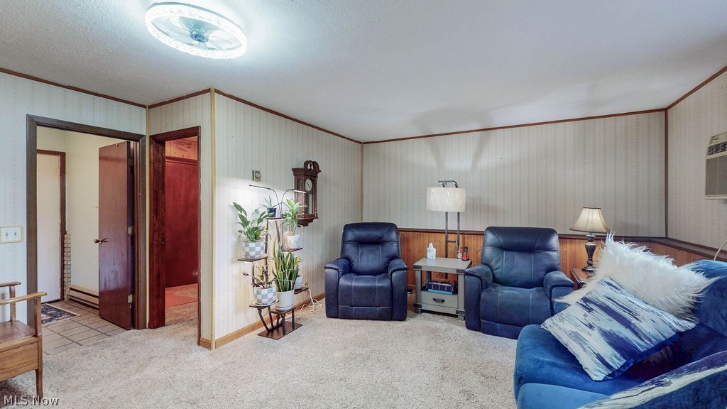 38667 Chestnut Ridge Road Elyria, OH 44035 - Photo 20 of 35 Carpeted living area featuring wallpapered walls with wood trim and wainscoting