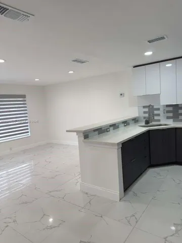 a kitchen with a sink cabinets and window