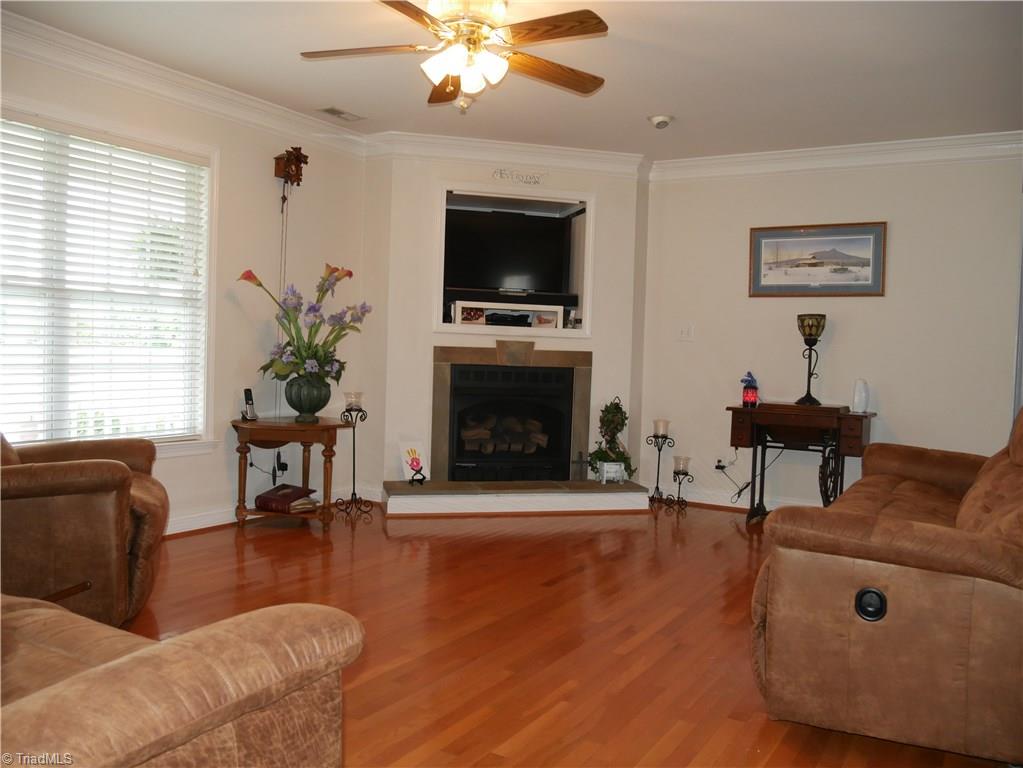 1615 Rosebud Road Walnut Cove, NC 27052 - Photo 2 of 20 GREAT ROOM with Hardwood floor, Ceiling Fan, Fireplace with gas logs.