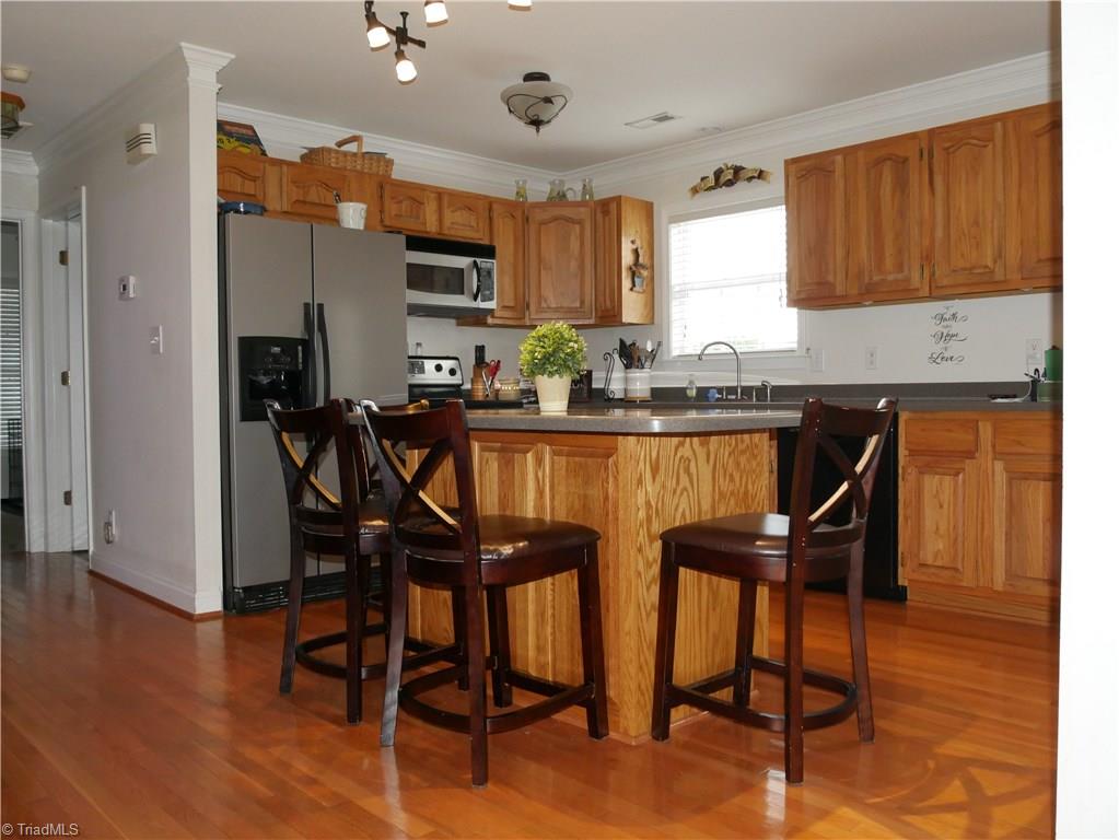 1615 Rosebud Road Walnut Cove, NC 27052 - Photo 3 of 20 Hardwood Floor, Corian Countertops, Recently installed new Bosch Dishwasher. New Bar lighting and Kitchen light fixture.