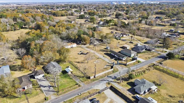 an aerial view of residential houses with outdoor space