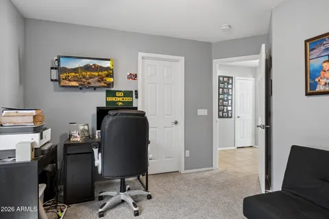 a view of a workspace with furniture and a window
