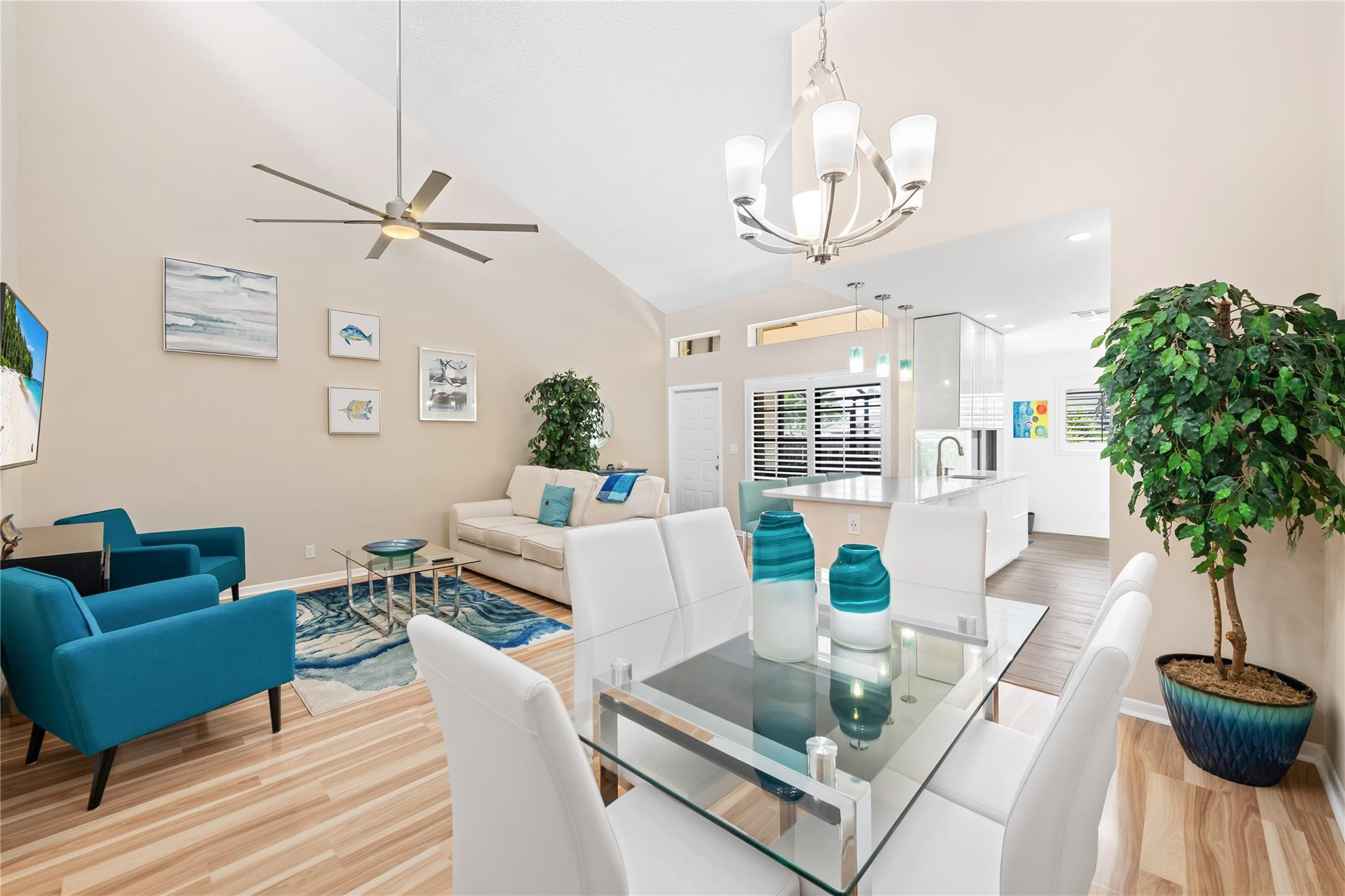 14067 Nesting Way, Unit C Delray Beach, FL 33484 - Photo 11 of 32 a living room with furniture a chandelier and a table