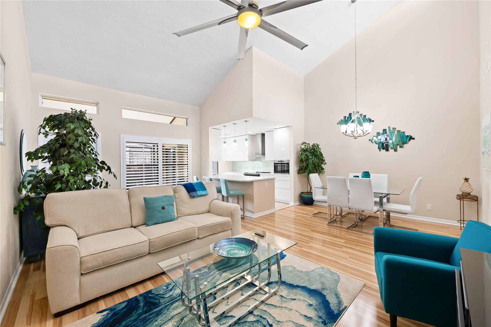 14067 Nesting Way, Unit C Delray Beach, FL 33484 - Photo 12 of 32 a living room with furniture a chandelier and a dining table