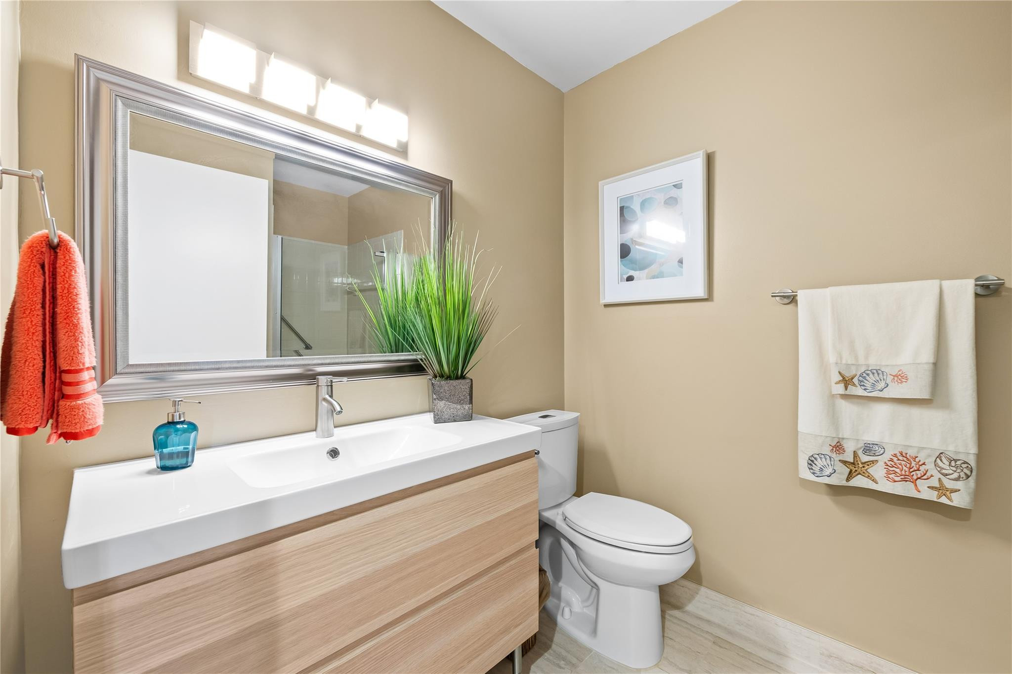 14067 Nesting Way, Unit C Delray Beach, FL 33484 - Photo 15 of 32 a bathroom with a toilet a sink and a mirror