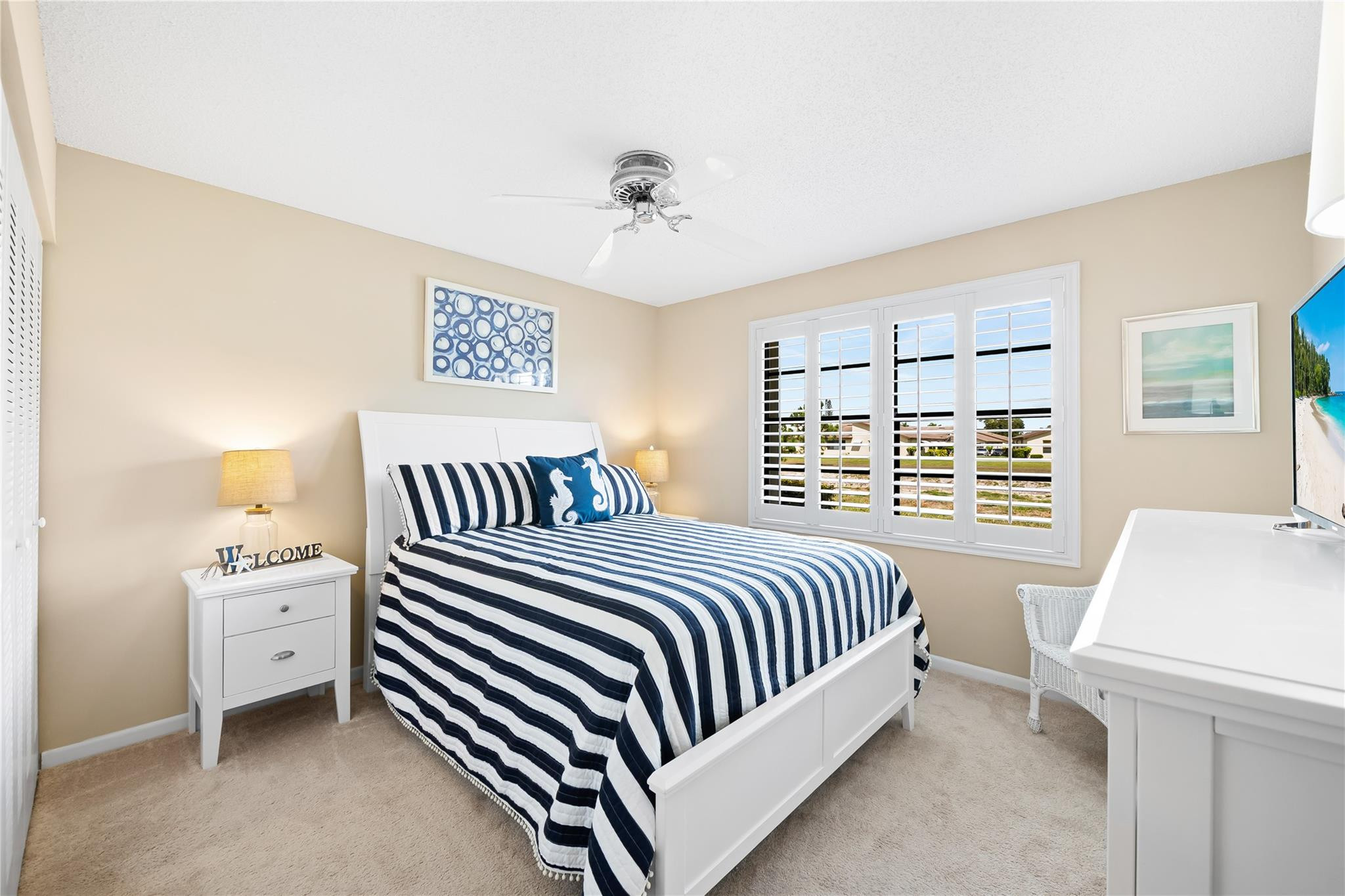 14067 Nesting Way, Unit C Delray Beach, FL 33484 - Photo 17 of 32 a bed room with a bed and a night stand