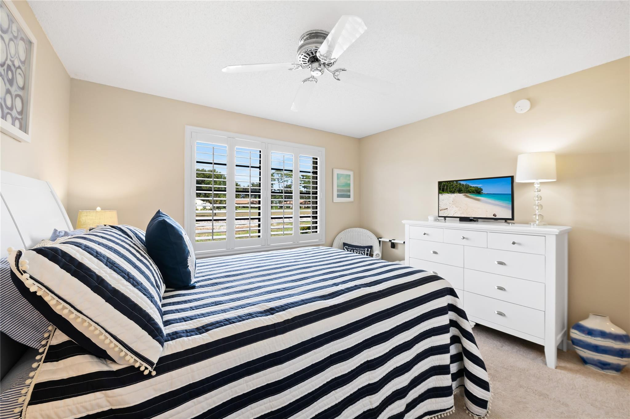 14067 Nesting Way, Unit C Delray Beach, FL 33484 - Photo 18 of 32 a bedroom with a bed and a flat screen tv