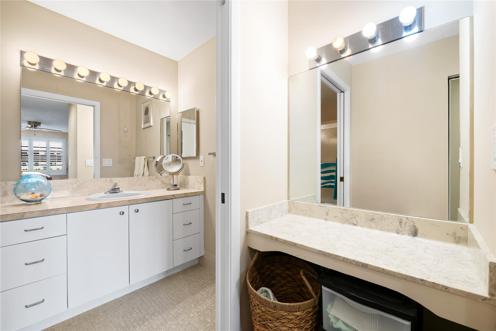 14067 Nesting Way, Unit C Delray Beach, FL 33484 - Photo 21 of 32 a bathroom with a sink a mirror and a window