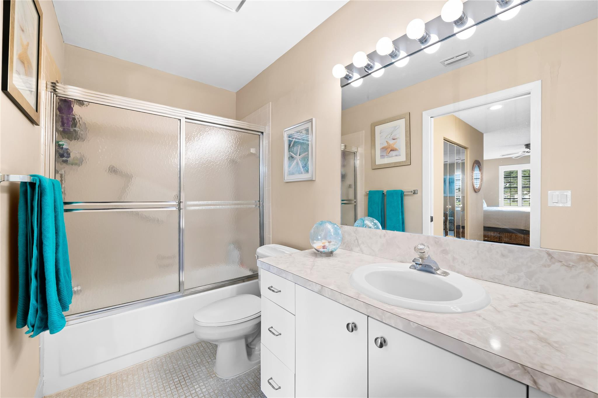 14067 Nesting Way, Unit C Delray Beach, FL 33484 - Photo 22 of 32 a bathroom with a sink toilet a mirror and shower