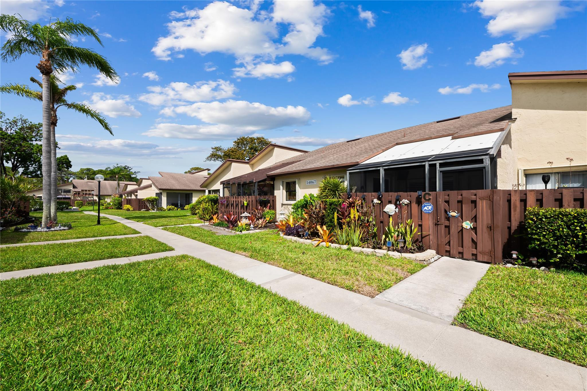 14067 Nesting Way, Unit C Delray Beach, FL 33484 - Photo 31 of 32 a view of house with a big yard and potted plants