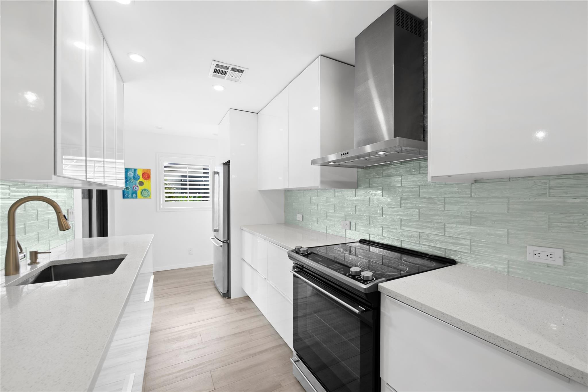 14067 Nesting Way, Unit C Delray Beach, FL 33484 - Photo 4 of 32 a kitchen that has a sink and a stove