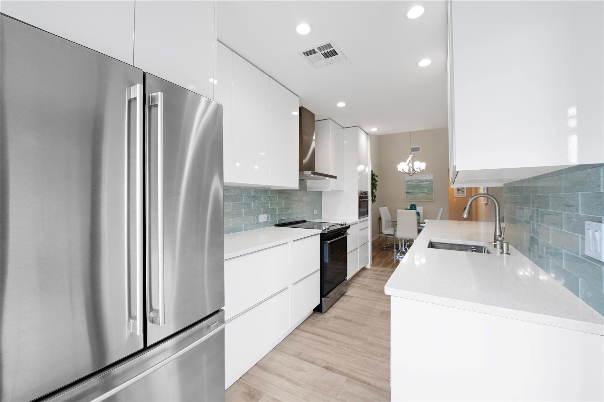 14067 Nesting Way, Unit C Delray Beach, FL 33484 - Photo 5 of 32 a large kitchen with a large counter top appliances and cabinets