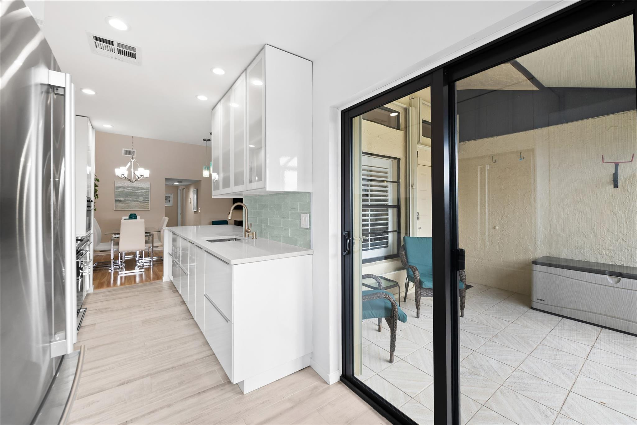 14067 Nesting Way, Unit C Delray Beach, FL 33484 - Photo 7 of 32 a kitchen with stainless steel appliances granite countertop a refrigerator and a sink