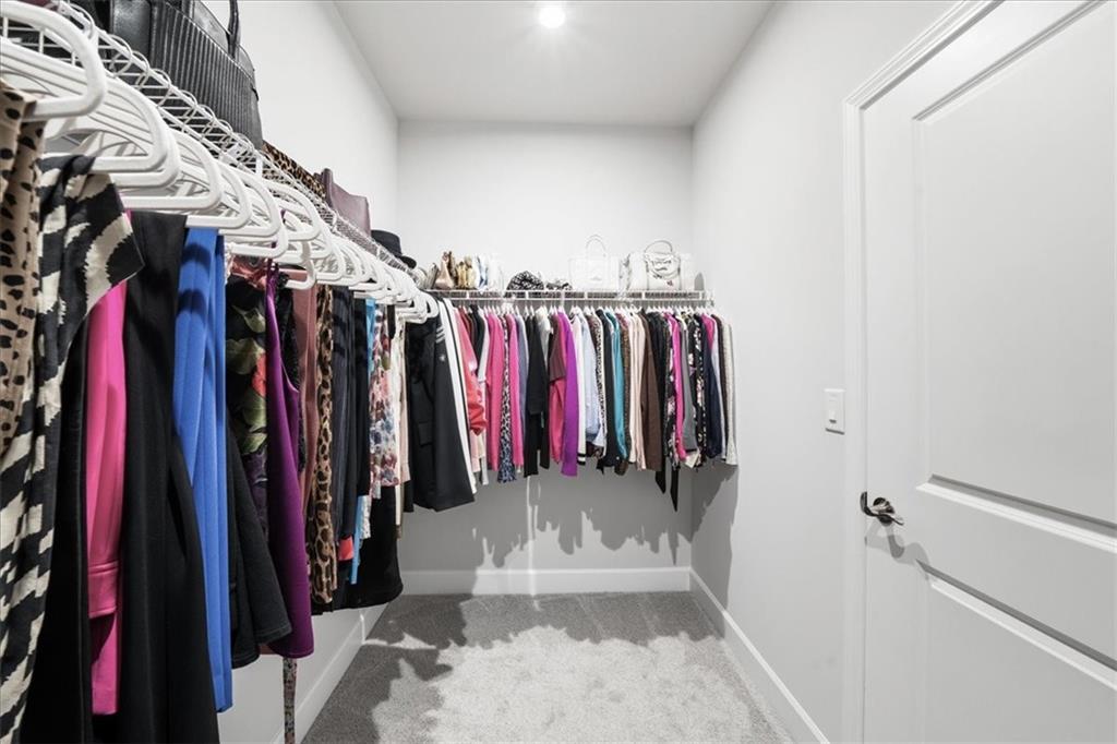 2457 Naples Street Hoschton, GA 30548 - Photo 21 of 41 a view of walk in closet with clothes
