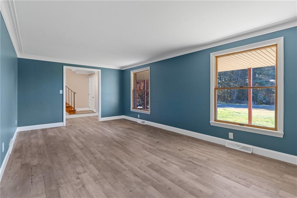 304 West Starz Road Cheswick, PA 15024 - Photo 7 of 48 a view of an empty room with wooden floor and a window