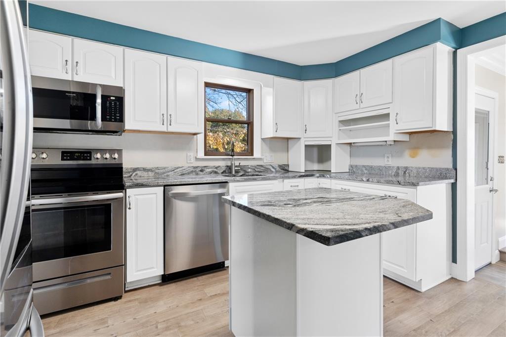 304 West Starz Road Cheswick, PA 15024 - Photo 8 of 48 a kitchen with stainless steel appliances granite countertop a sink stove and microwave
