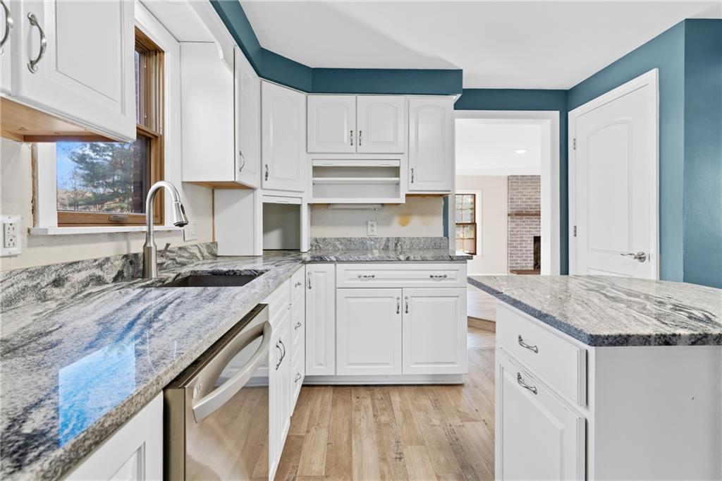 304 West Starz Road Cheswick, PA 15024 - Photo 9 of 48 a kitchen with granite countertop white cabinets and white appliances