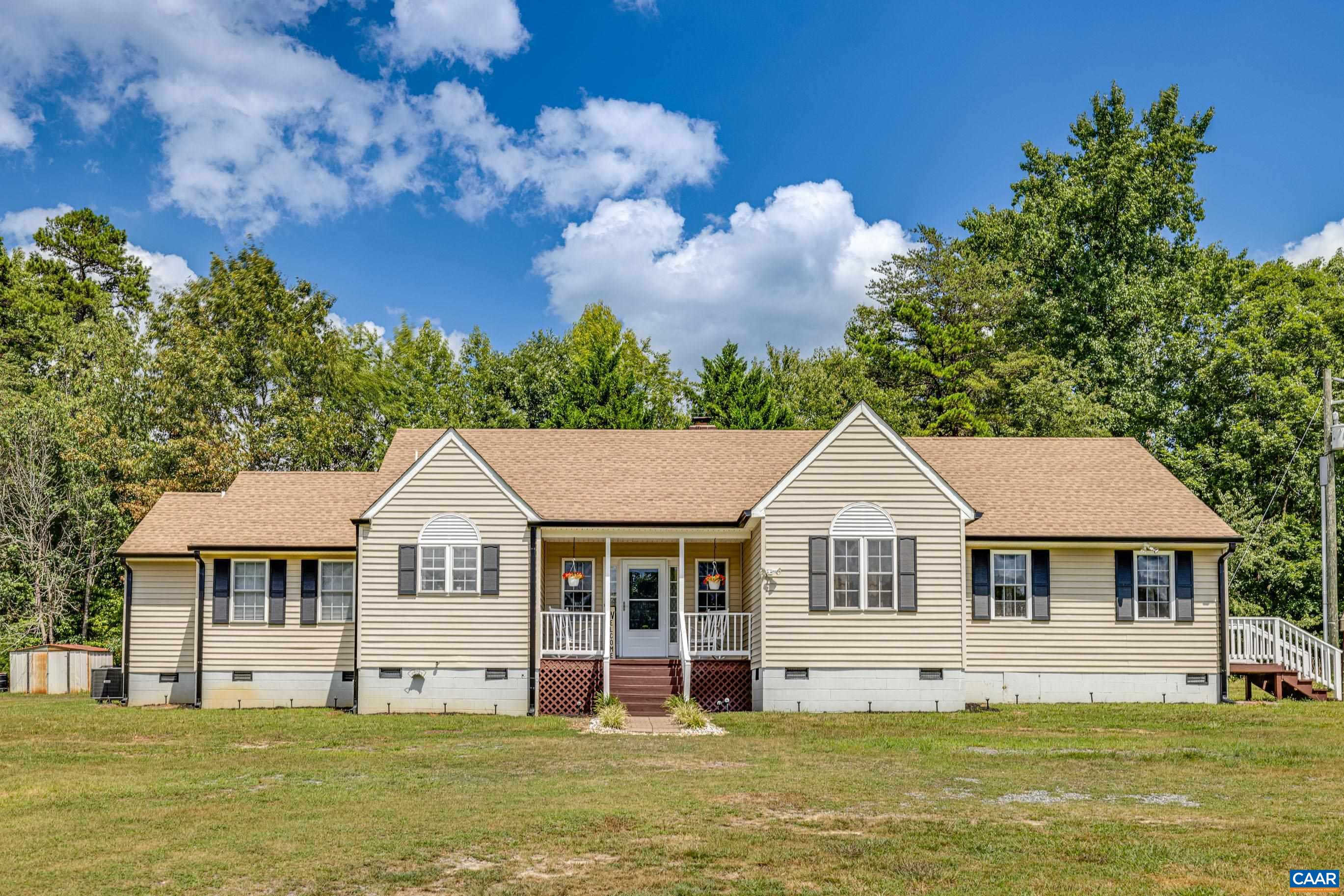 7839 Venable Road Kents Store, VA 23084 - Photo 1 of 51 a front view of a house with a garden and trees