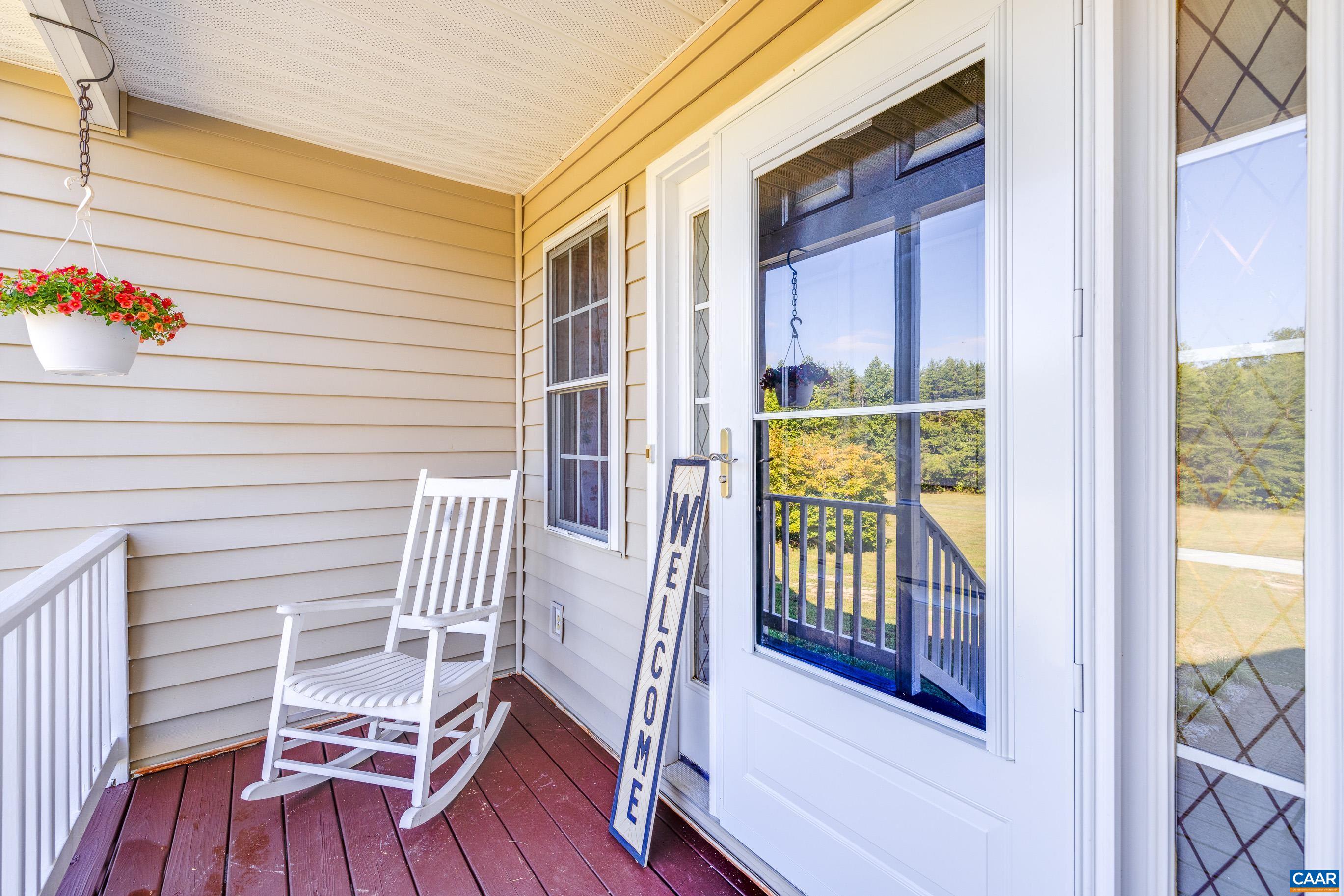 7839 Venable Road Kents Store, VA 23084 - Photo 12 of 51 a view of balcony with two chairs and wooden floor