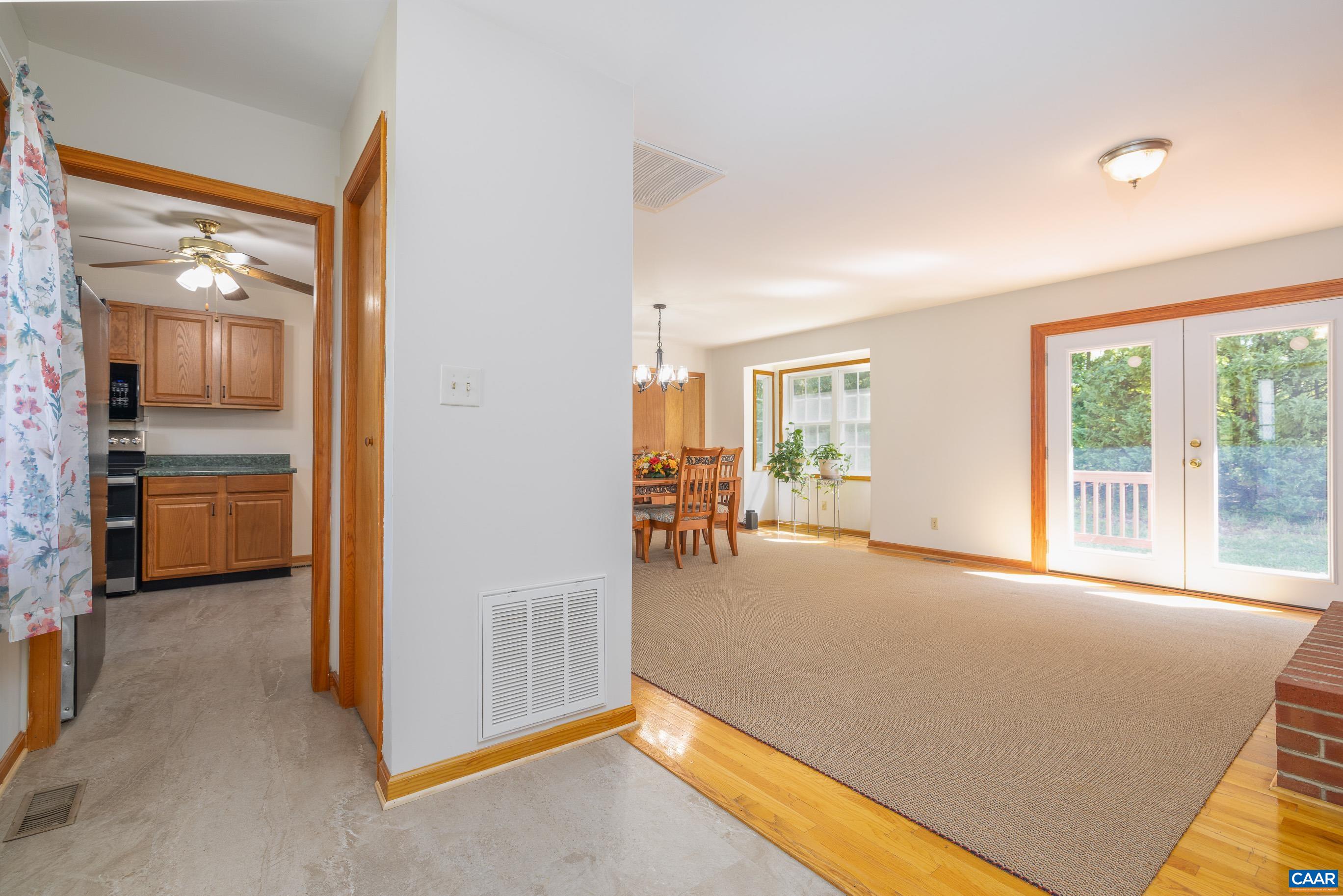 7839 Venable Road Kents Store, VA 23084 - Photo 14 of 51 a view of an empty room and kitchen with furniture and windows