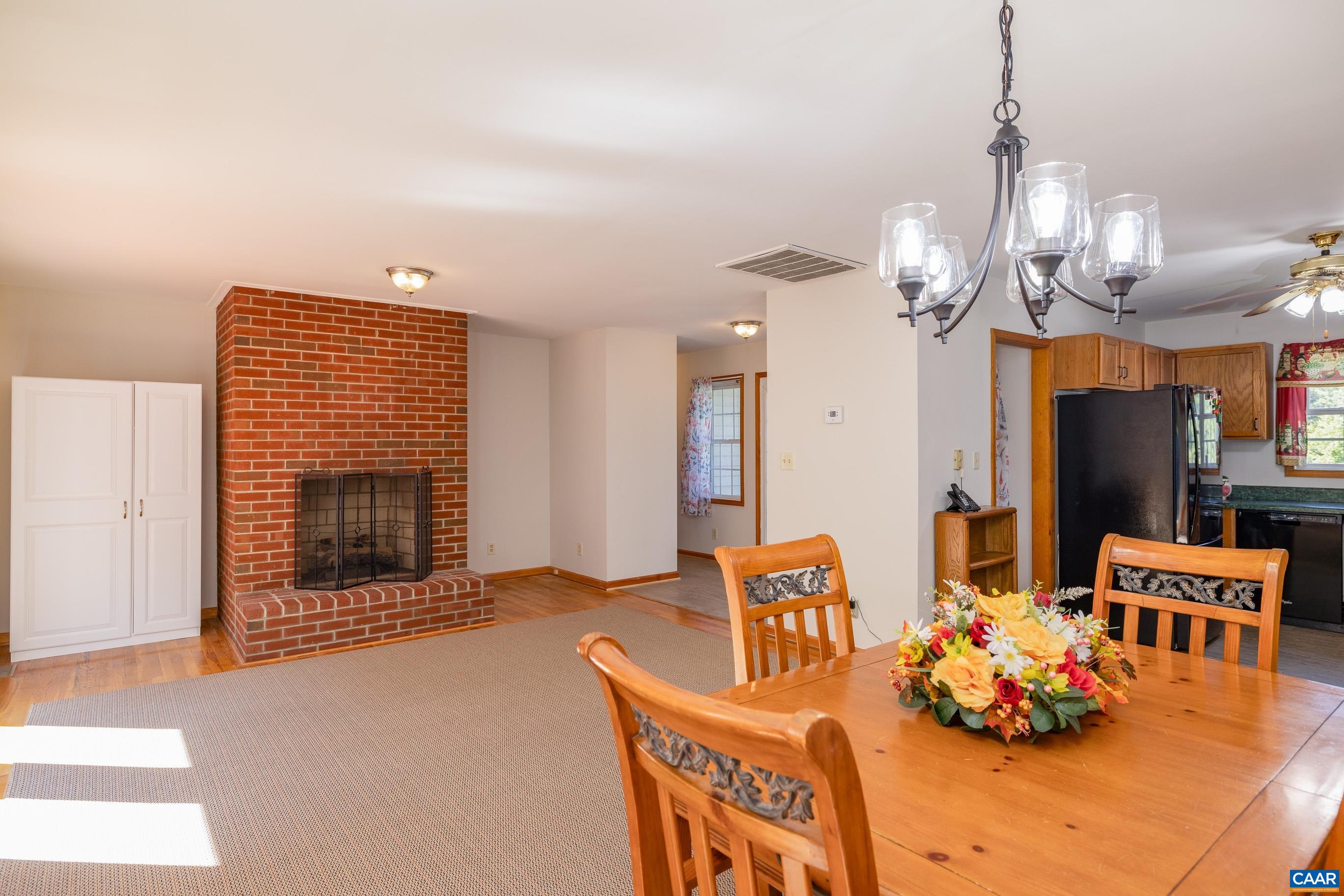 7839 Venable Road Kents Store, VA 23084 - Photo 18 of 51 a living room with furniture kitchen view and a chandelier