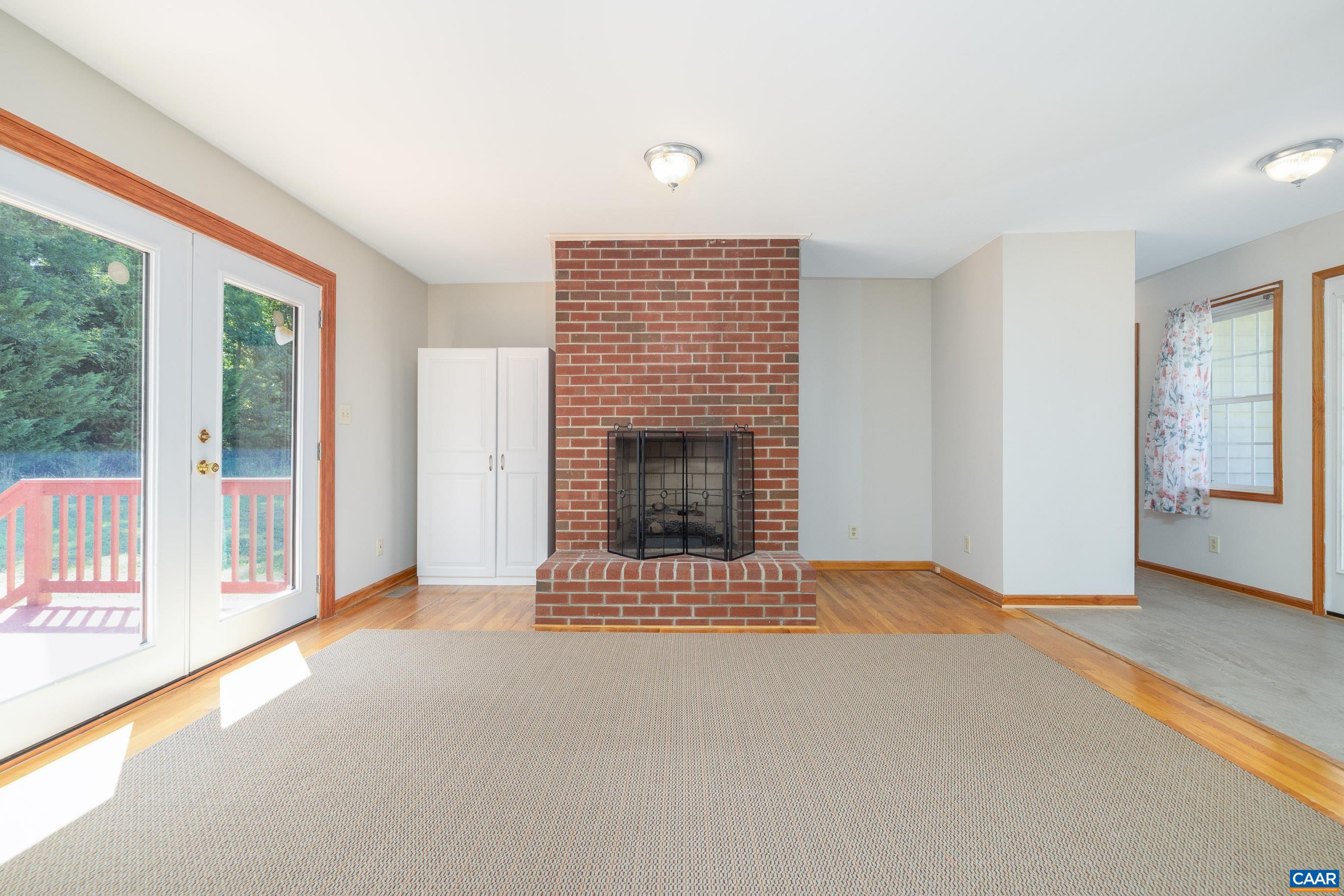 7839 Venable Road Kents Store, VA 23084 - Photo 19 of 51 a view of an empty room with a fireplace and a window