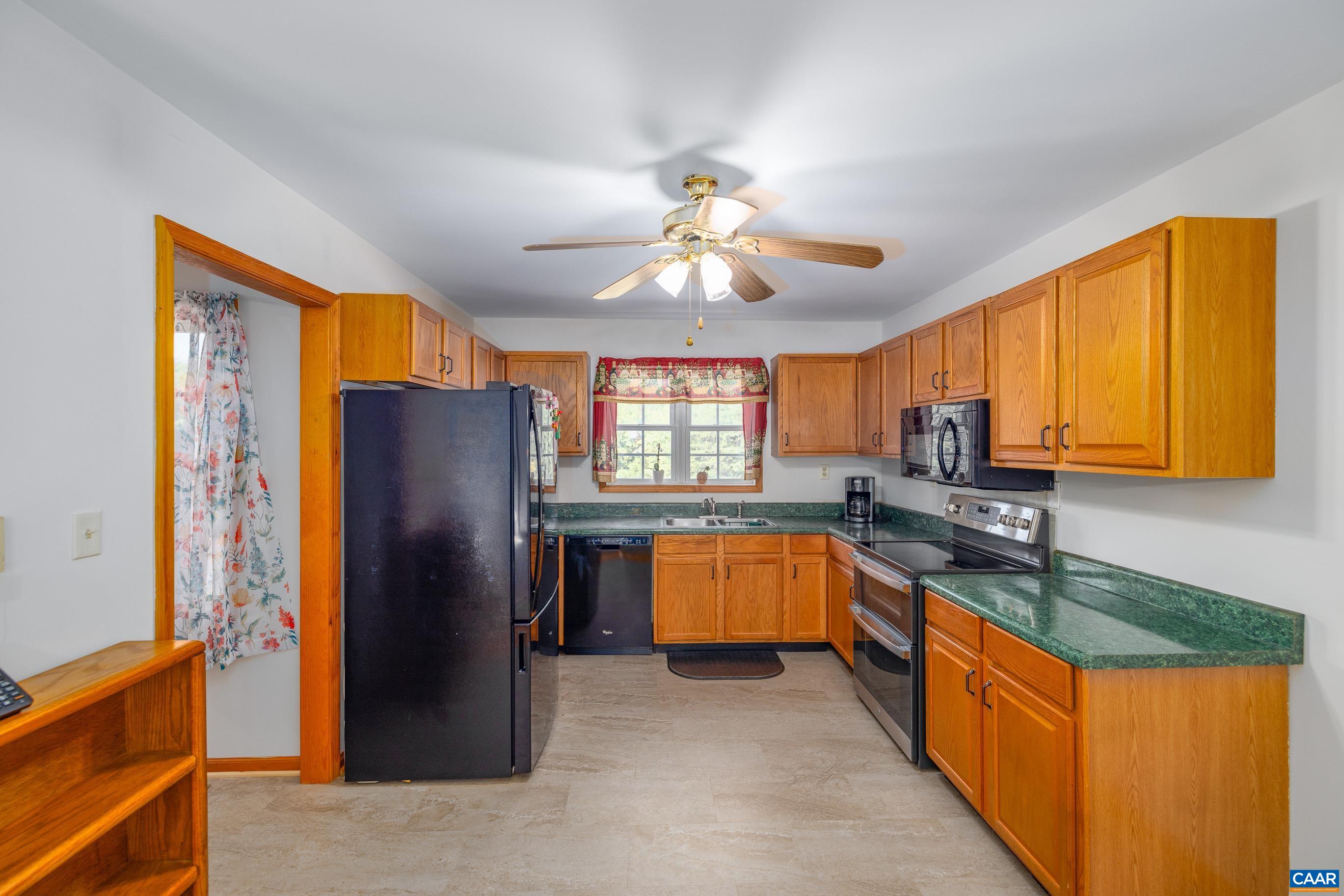 7839 Venable Road Kents Store, VA 23084 - Photo 21 of 51 a kitchen with stainless steel appliances granite countertop a refrigerator a sink dishwasher a stove with wooden cabinets and floor